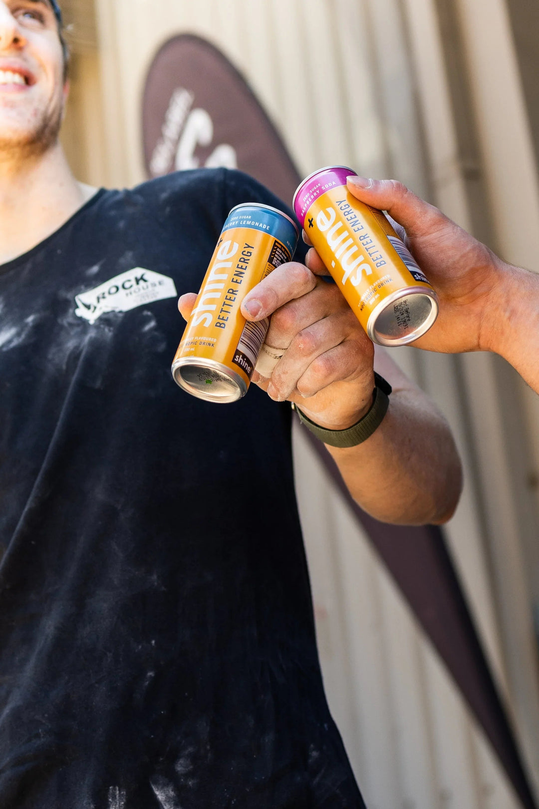 Two people toasting with Shine Better Energy nootropic drinks outdoors