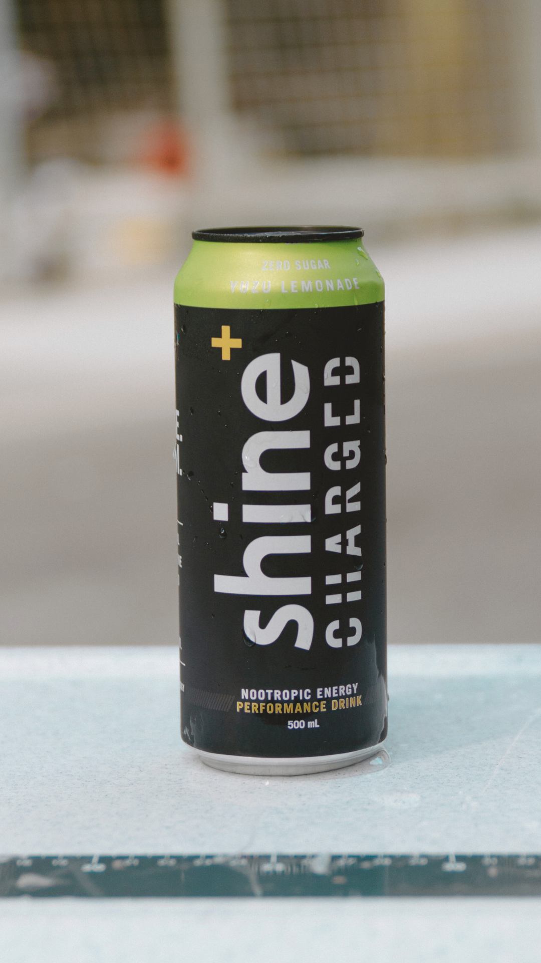 Chilled can of nootropic energy drink, yuzu lemonade flavor, on an outdoor surface