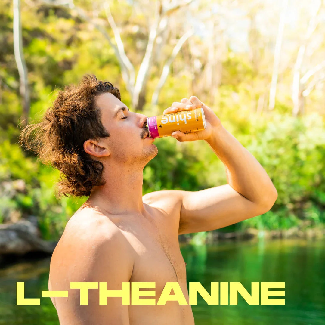 Man outdoors drinking nootropic beverage with L-theanine, energy and focus drink by water