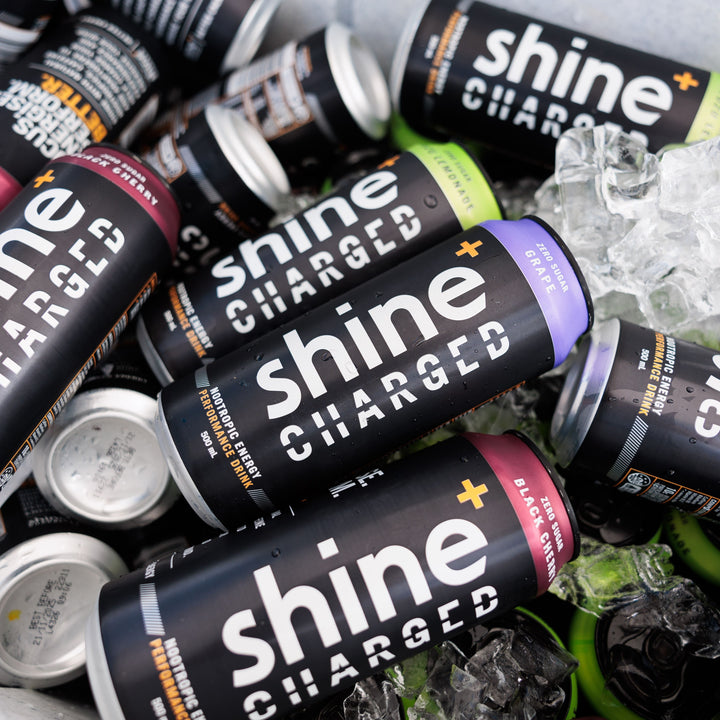 Shine Charged nootropic energy drink cans assorted flavors on ice
