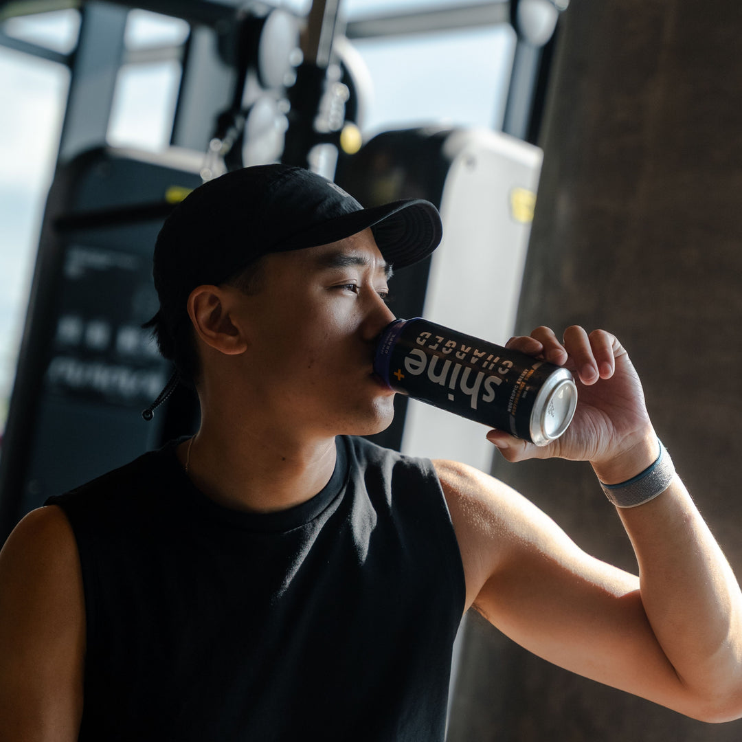 Man in gym drinks canned nootropic energy drink, natural brain-boost beverage