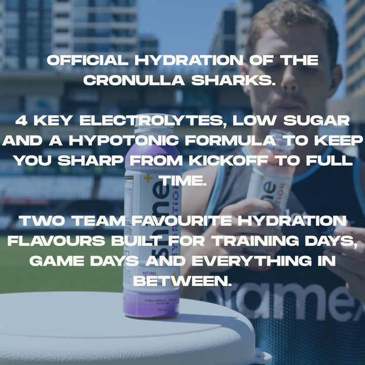 Athlete holding nootropic drink bottle on sports field, hydration and electrolytes focus