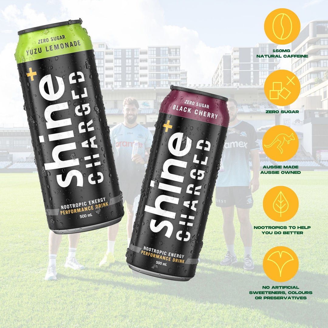 shine charged nootropic energy drinks yuzu lemonade and black cherry cans on sports field